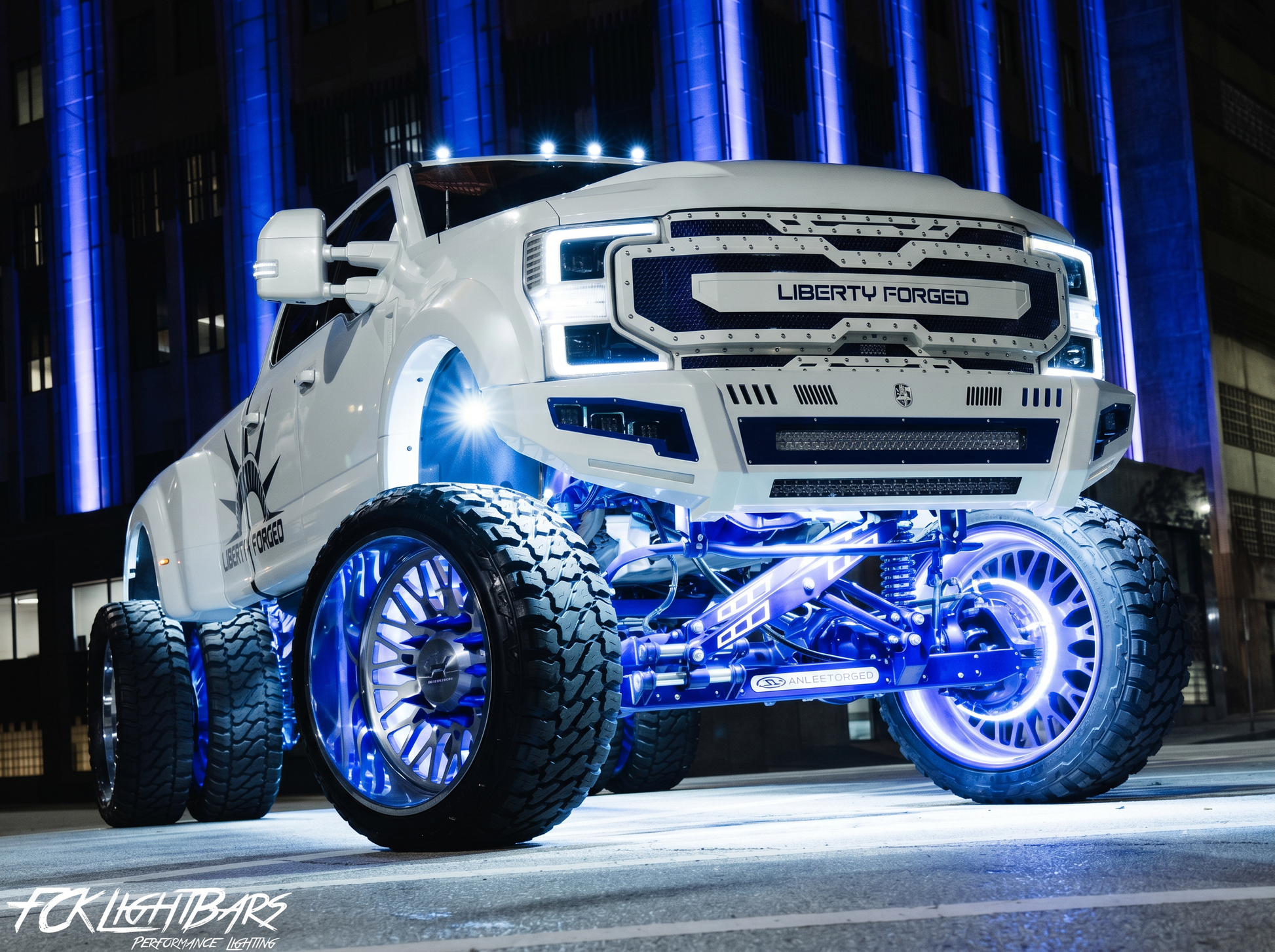 Show truck with glowing LED wheel lights at night